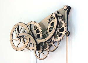 1/4 view of clock head hung on a white wall.