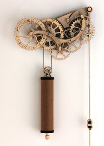 Front facing view of clock & pendulum. Hung on White wall.